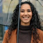 Woman smiling in the rain in Modesto and [test_shortcode]